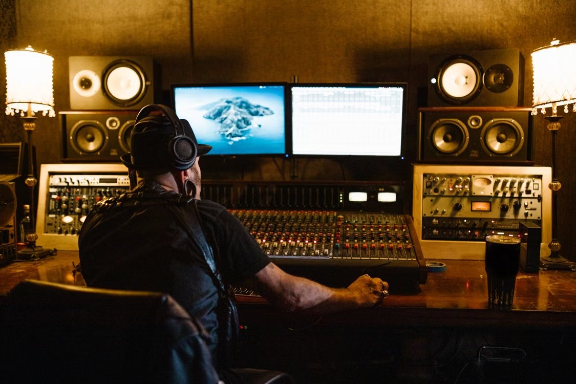 Audio engineer mixing cinematic sound effects at a professional studio console