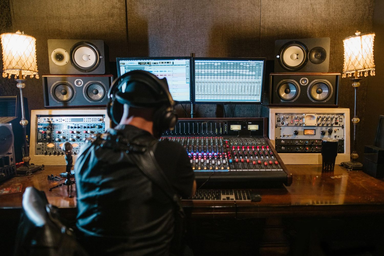 A music producer mixing at a studio console — the craft behind CinematicSFX